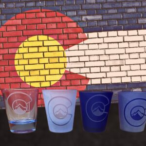 Clear and blue shot glasses sand blasted logo and frosted glass. Colorado Custom Decor.